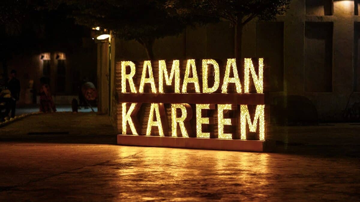 Ramadan kareem is illuminated at night.