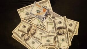 a pile of twenty dollar bills sitting on top of a table