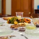 a table with plates and bowls of food on it