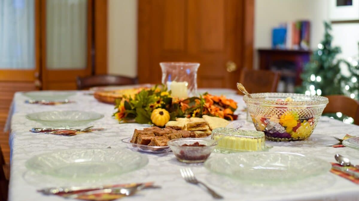 a table with plates and bowls of food on it