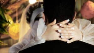 man in black shirt covering face with white textile
