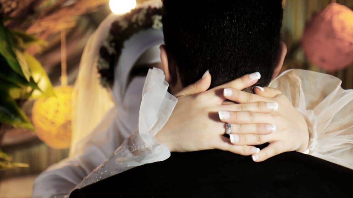 man in black shirt covering face with white textile