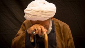 person in brown coat and white knit cap