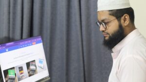 A man sitting at a desk using a computer