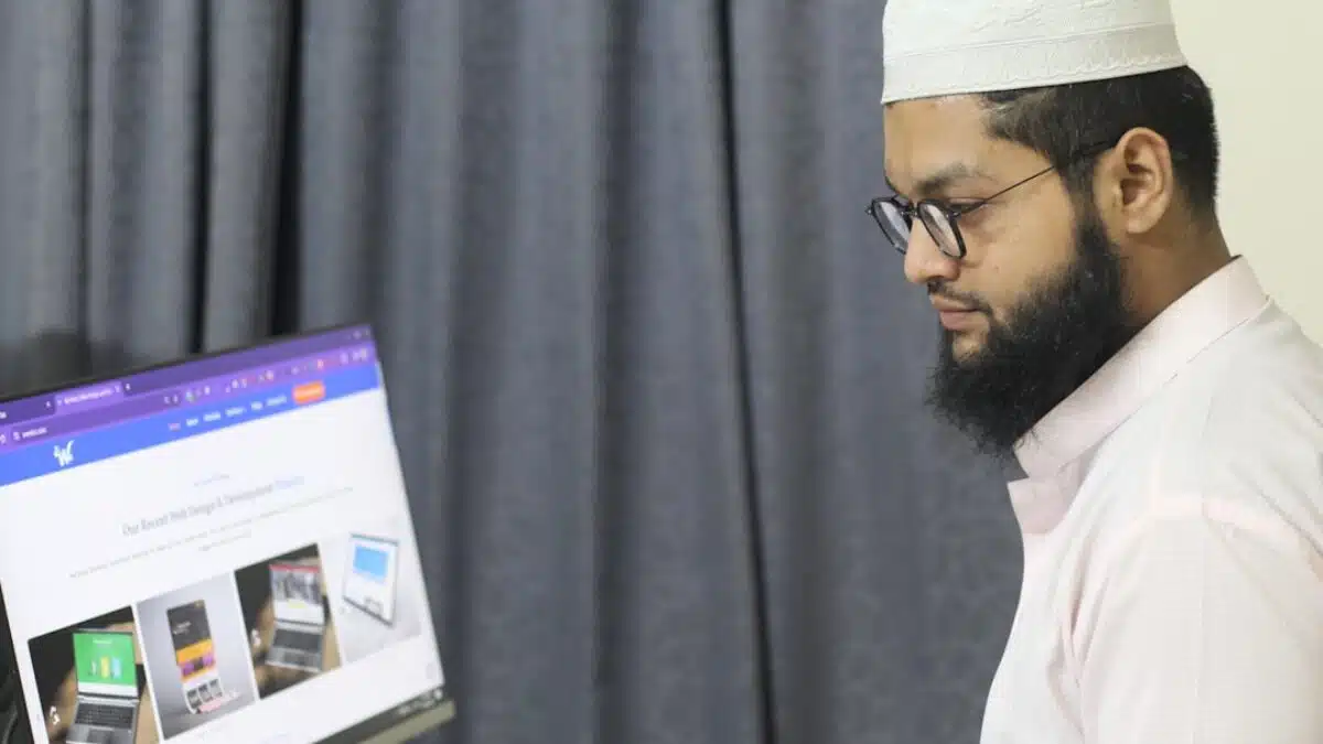 A man sitting at a desk using a computer