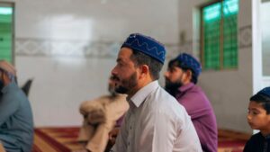 a group of men sitting on the floor in a room