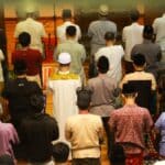 a large group of people standing in a room