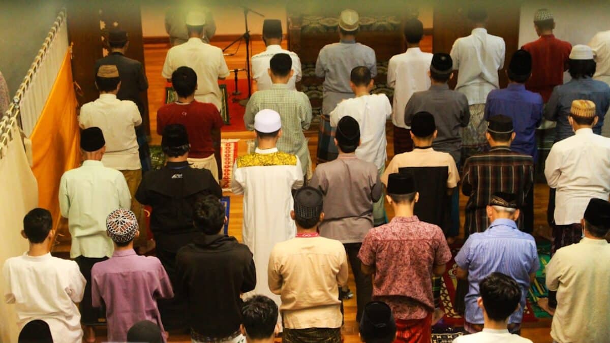 a large group of people standing in a room
