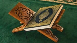An open book sitting on top of a wooden stand