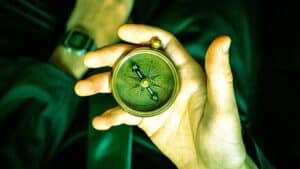 A person holding a compass in their hand