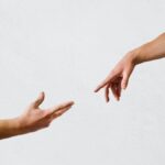 persons hand on white wall