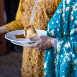 a person holding a plate of food