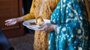 a person holding a plate of food