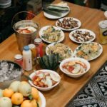 a wooden table topped with bowls of food