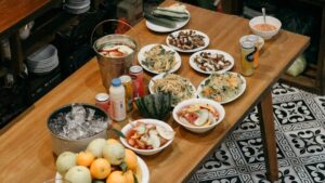 a wooden table topped with bowls of food